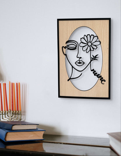 Bloomed Eye wall art in one-line art style featuring a woman’s face with one eye covered by a daisy, drawn in minimalist black lines with natural wood tones. Perfect for floral, modern, and minimalist decor.