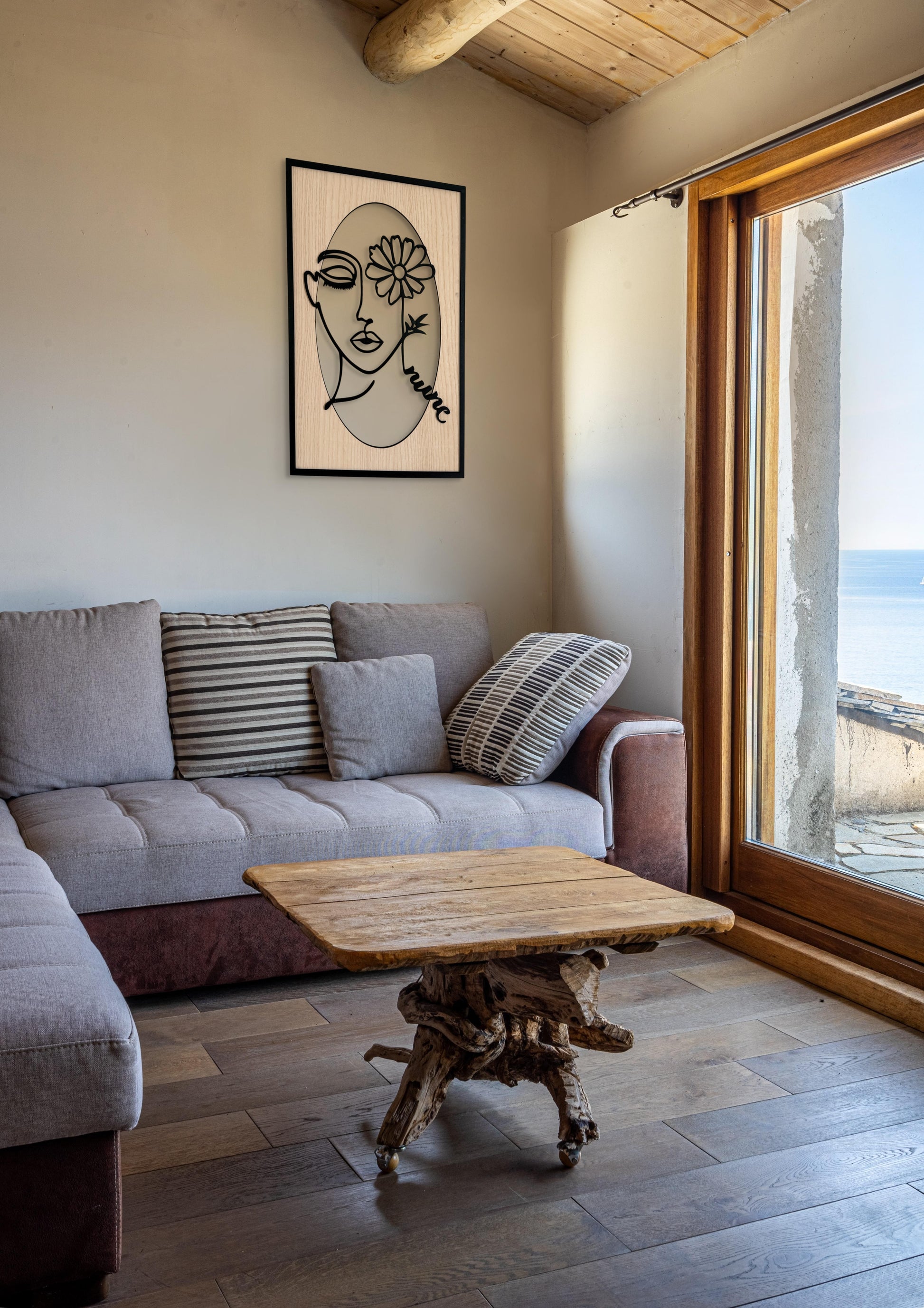 Bloomed Eye wall art in one-line art style featuring a woman’s face with one eye covered by a daisy, drawn in minimalist black lines with natural wood tones. Perfect for floral, modern, and minimalist decor.