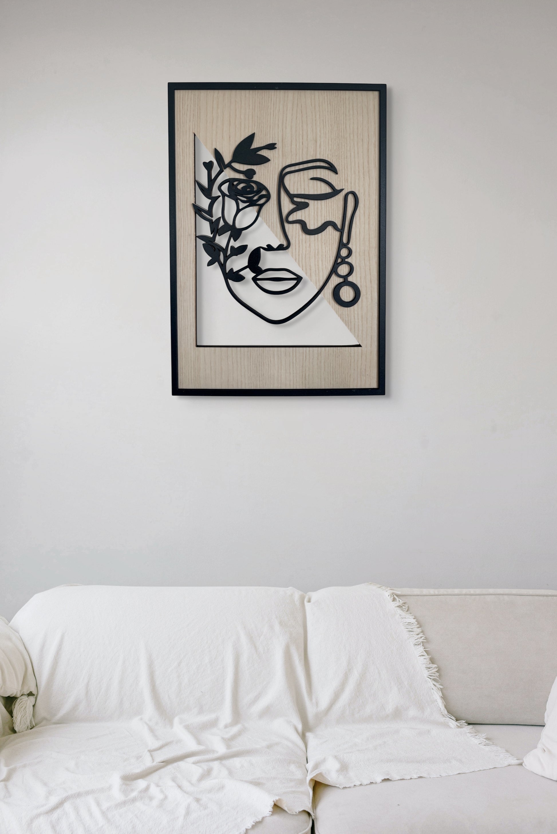 Floral Whisper wall art in one-line art style featuring a woman’s face half-covered by delicate flowers, drawn in minimalist black lines with natural wood tones. Perfect for floral, modern, and minimalist decor.