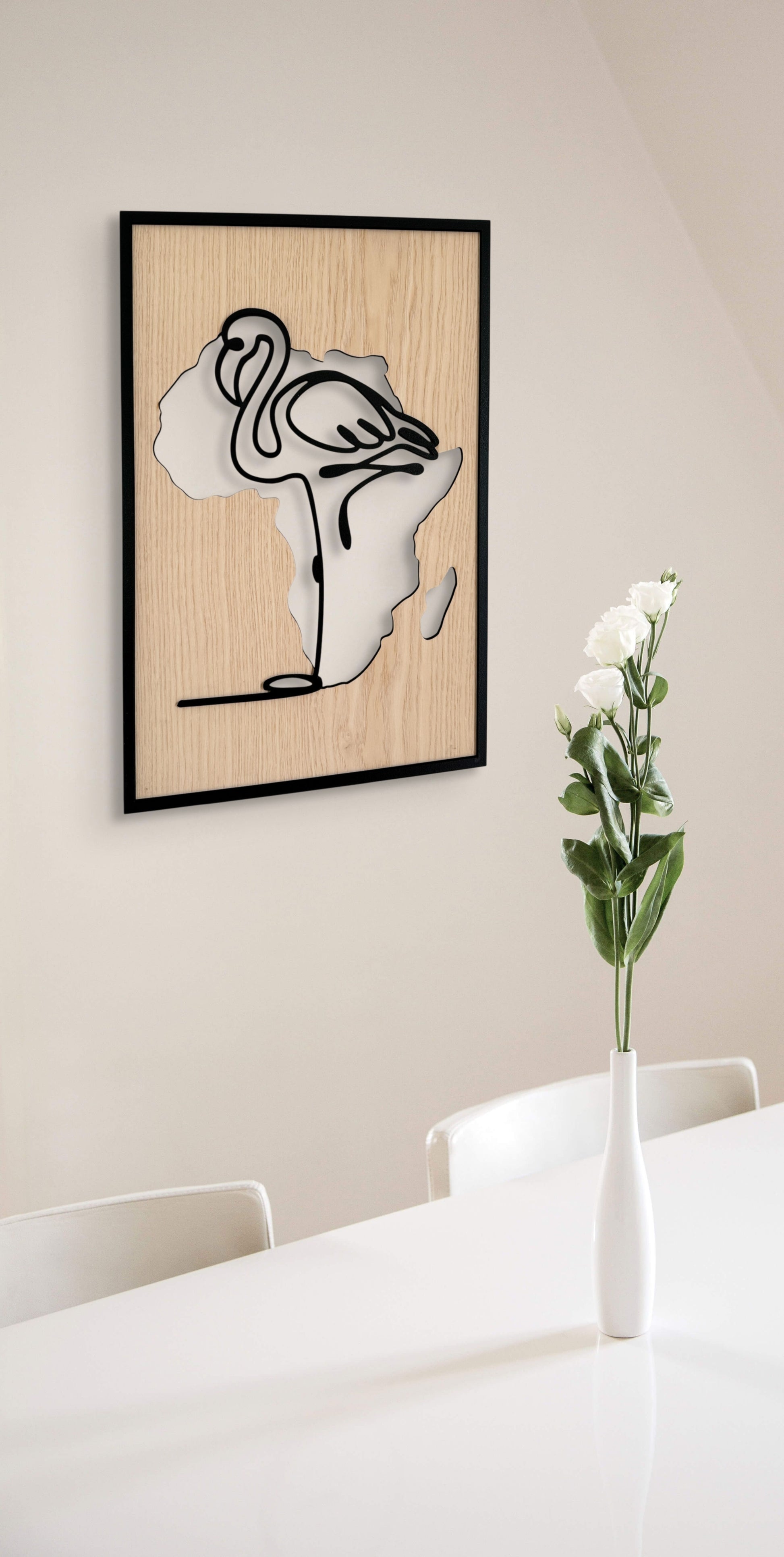 Flamingo wall art in one-line art style featuring a flamingo with the Africa continent shape in the background, using minimalist black lines and natural wood tones. Perfect for modern, safari-inspired decor.