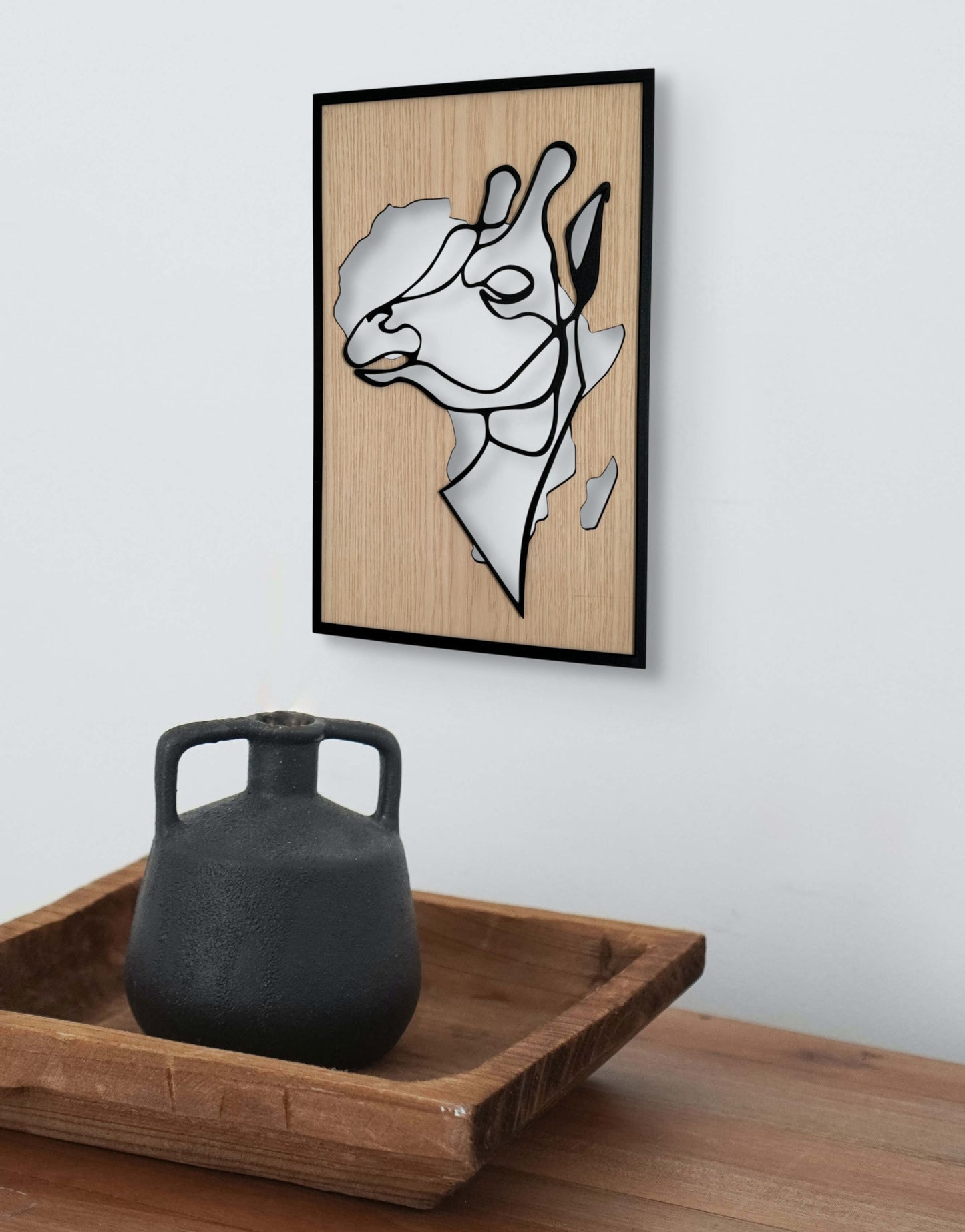Tall Grace wall art in one-line art style featuring a graceful giraffe with the shape of Africa in the background, using minimalist black lines and wood tones. Ideal for safari-themed and modern decor.