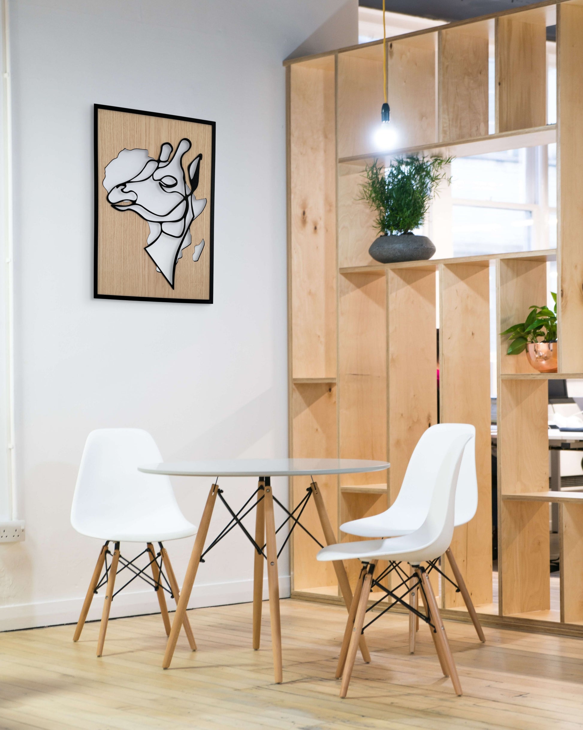 Tall Grace wall art in one-line art style featuring a graceful giraffe with the shape of Africa in the background, using minimalist black lines and wood tones. Ideal for safari-themed and modern decor.