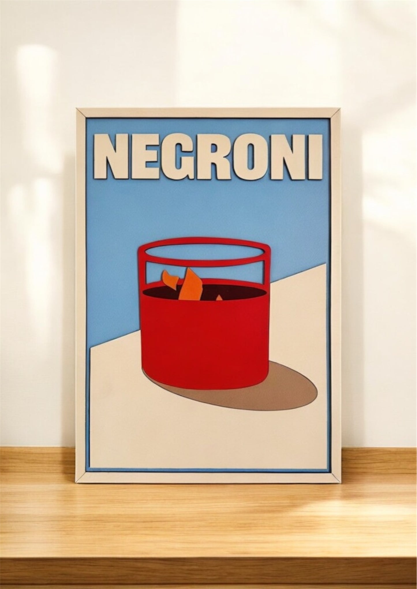 Negroni cocktail wall art in modern minimalist style with bold red drink glass, orange garnish, and blue background – laser cut wooden bar decor sign
