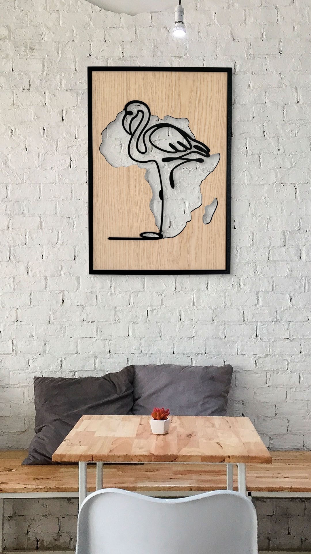 Flamingo wall art in one-line art style featuring a flamingo with the Africa continent shape in the background, using minimalist black lines and natural wood tones. Perfect for modern, safari-inspired decor.